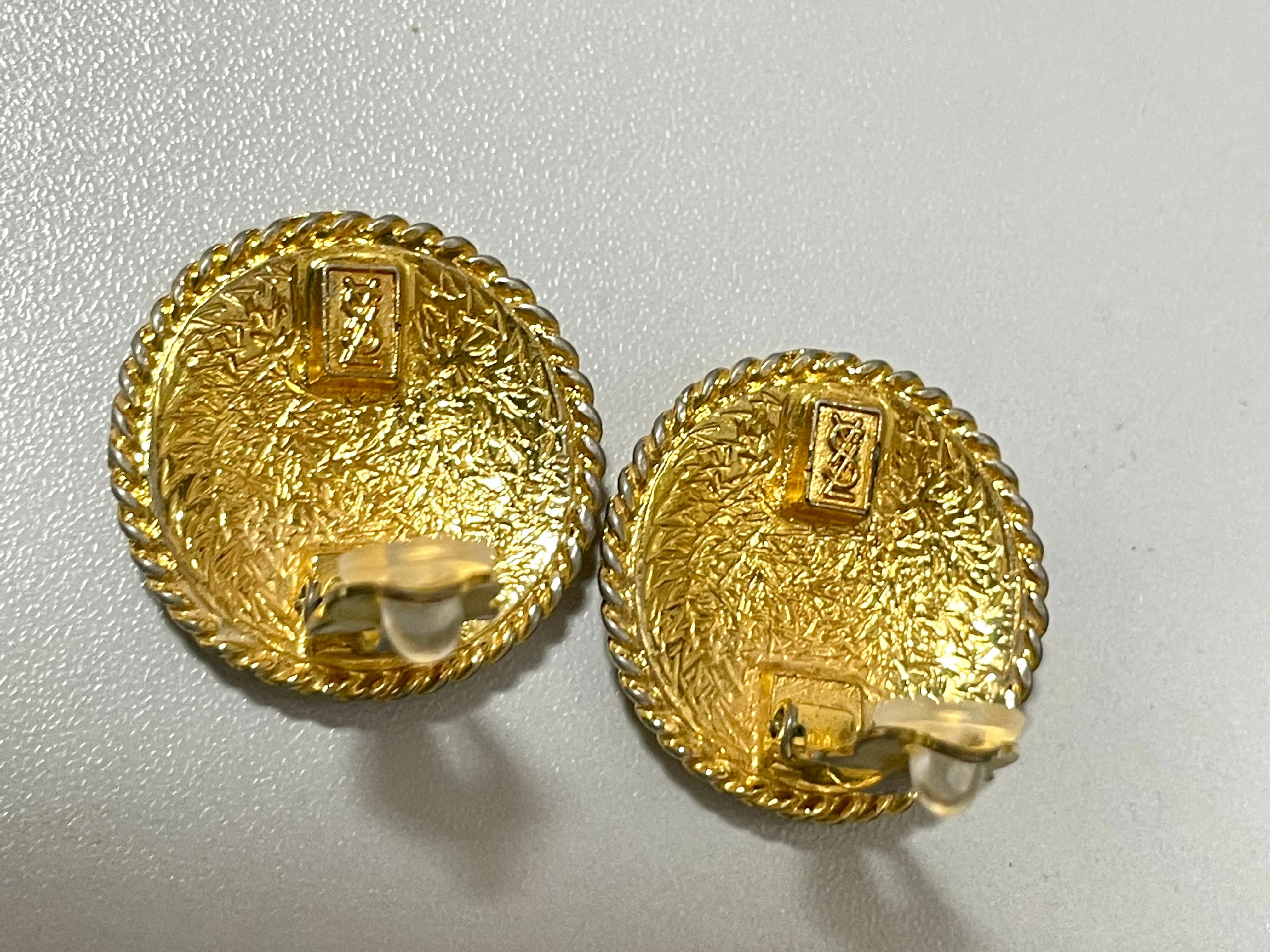 Vintage Yves Saint Laurent golden round logo earring with engraved signature. 0410132