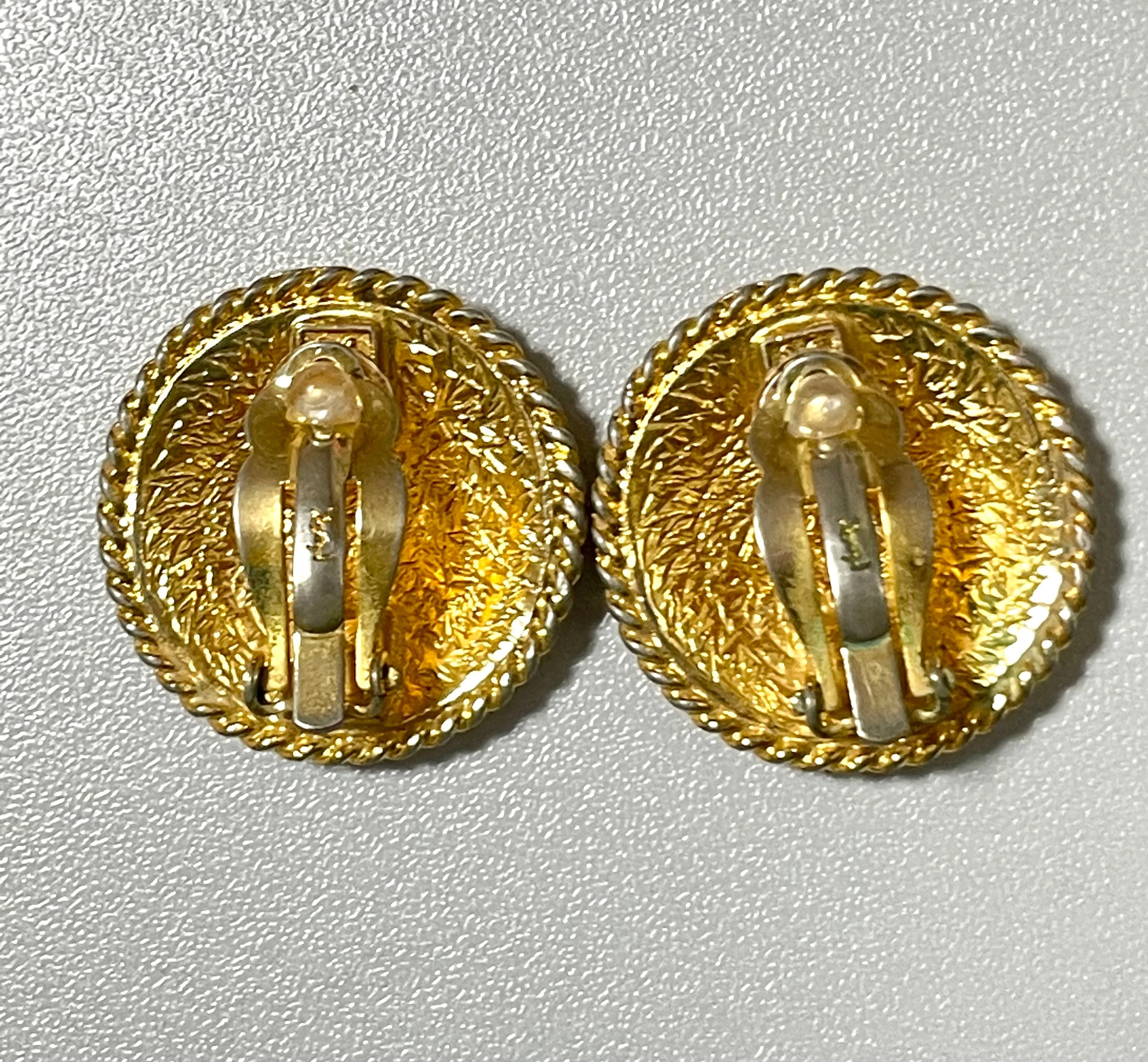 Vintage Yves Saint Laurent golden round logo earring with engraved signature. 0410132
